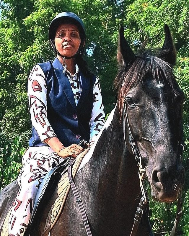 Mrs. Ezhilarasi Jayaraman, Managing Director of Shri Surya Horse Riding Training Centre, mounted on a dark native horse