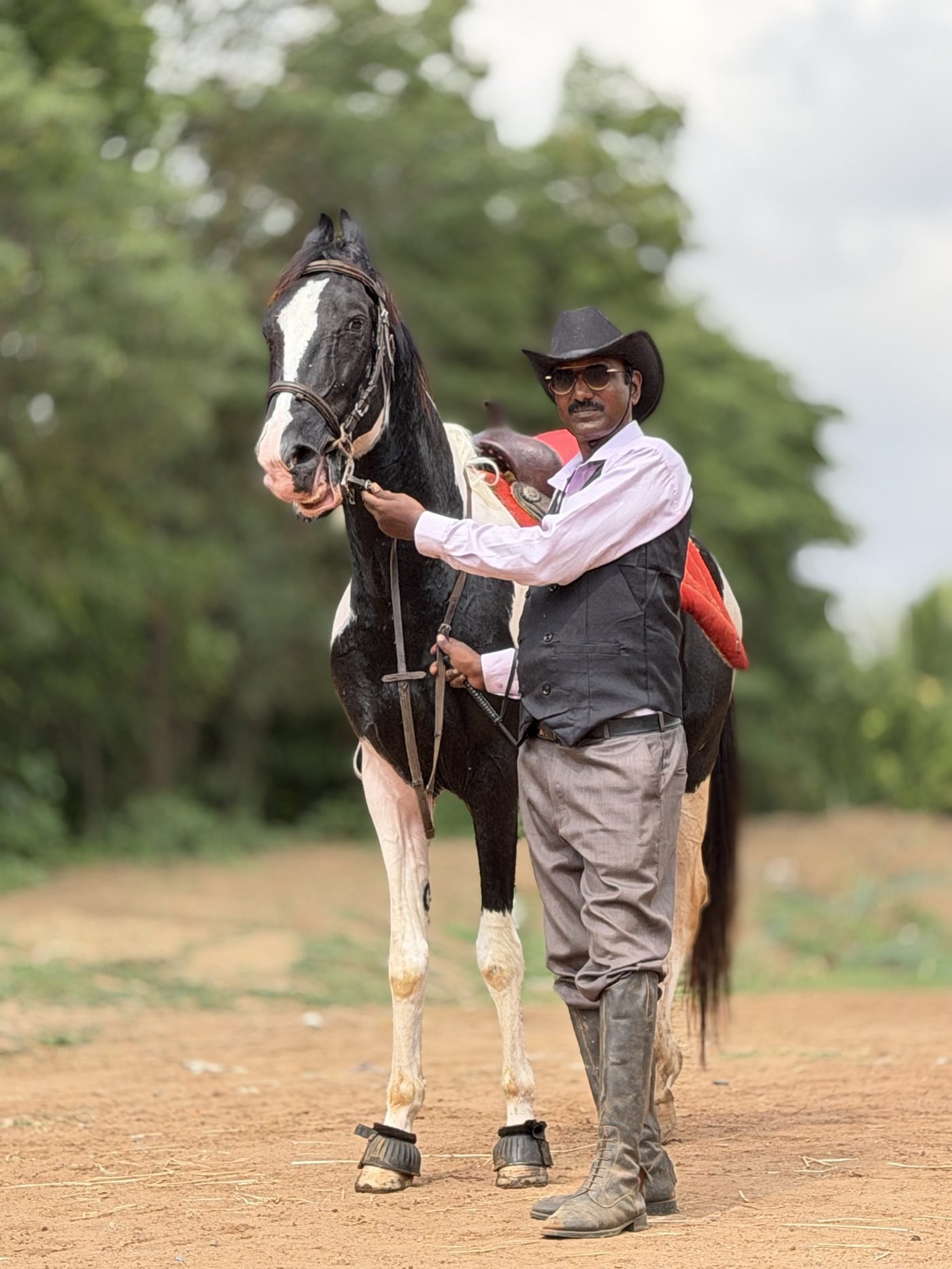 Mr. S. Balasubramanian, Founder of Shri Surya Horse Riding Training Centre, with a native pinto horse